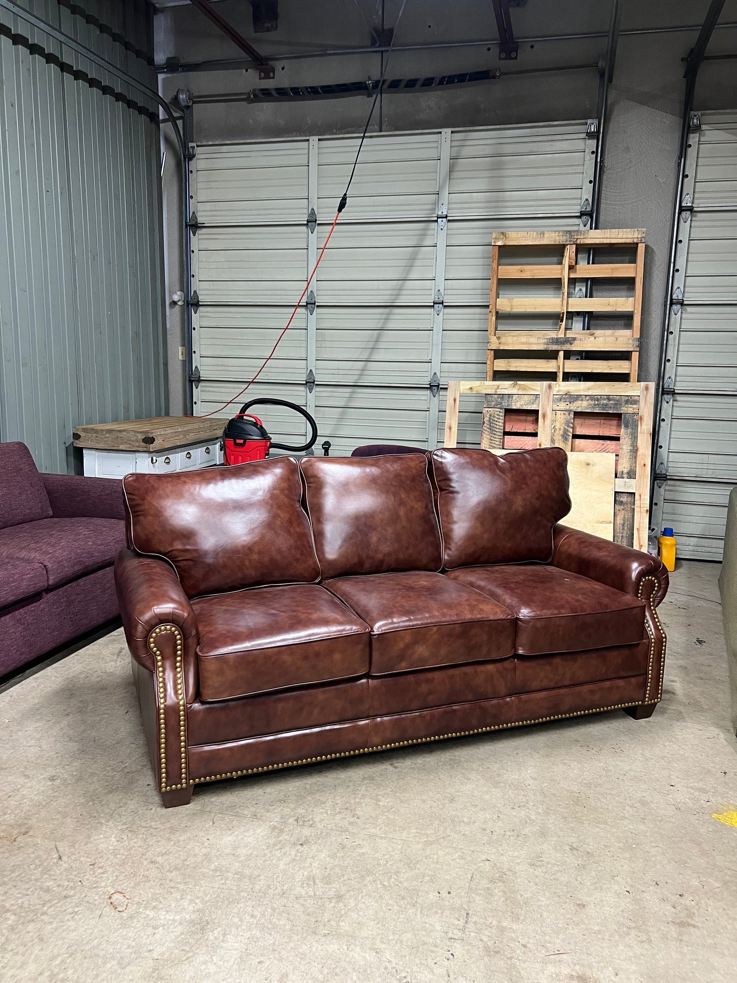 Studded leather pull out bed sofa