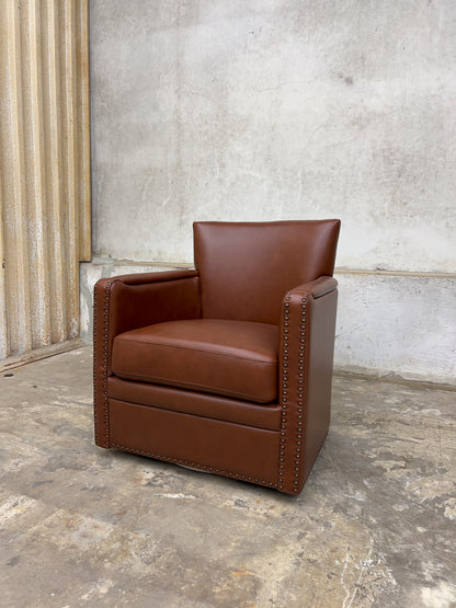 contemporary genuine leather swivel chair with nailhead trim on the arms
