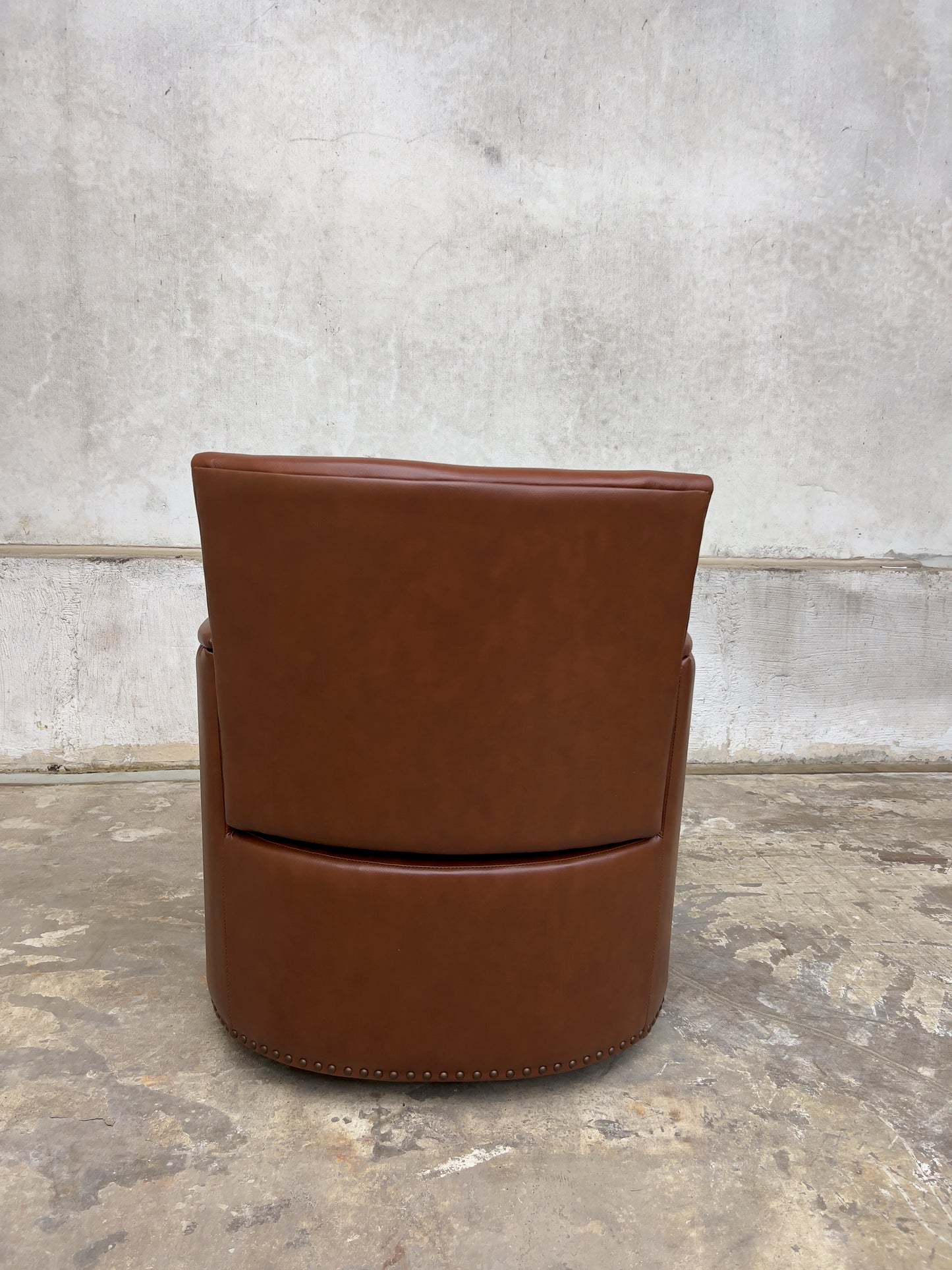 contemporary genuine leather swivel chair with nailhead trim on the arms