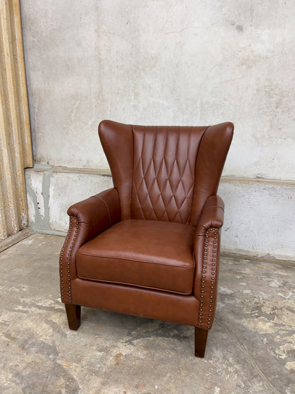 Genuine leather armchair featuring nailhead trims and solid wood legs.