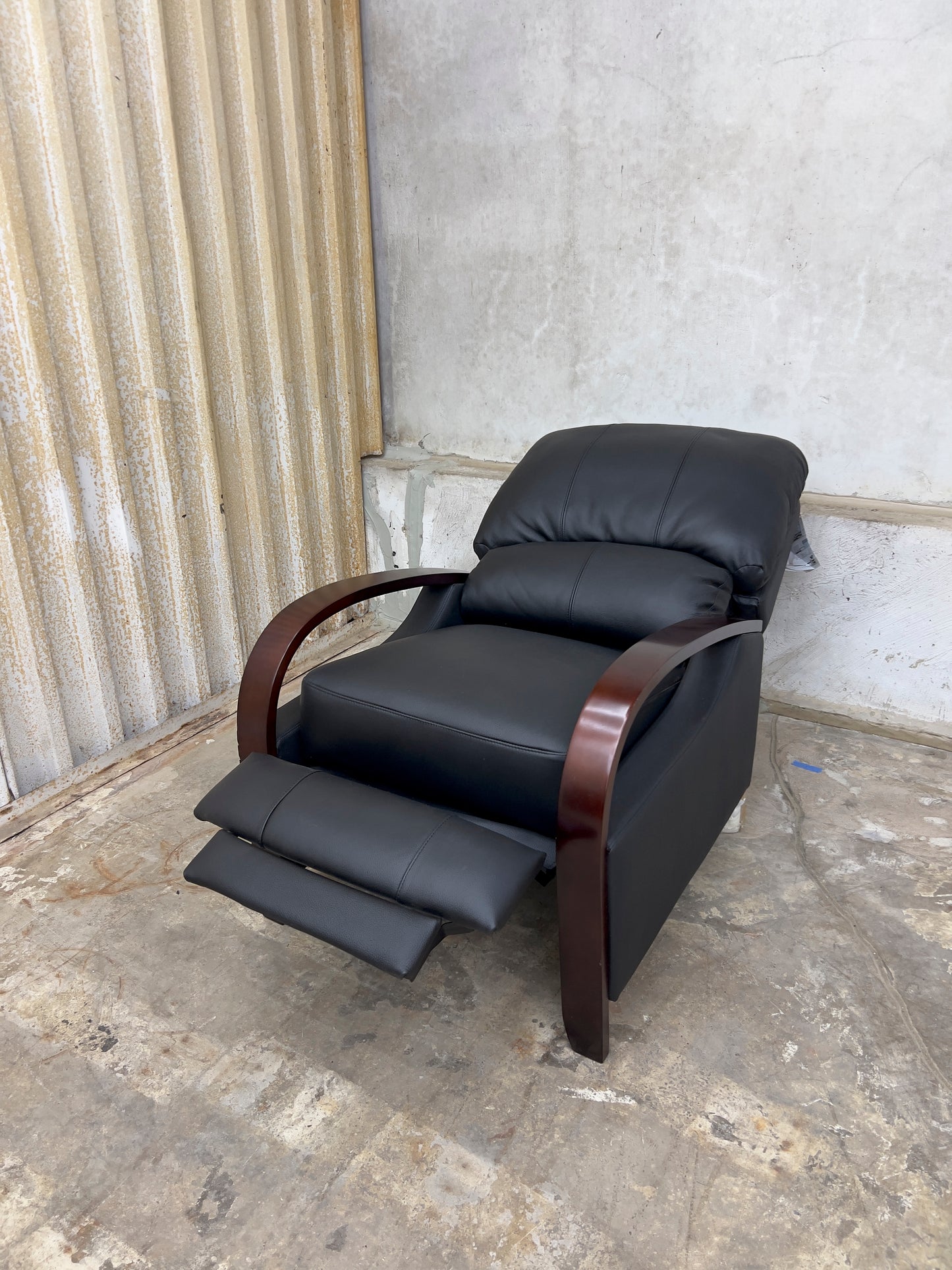 Black Genuine Leather Recliner with Wooden Armrests.