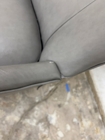 Grey Armchair, which features vegan leather upholstery, nailhead trim, and metal legs.