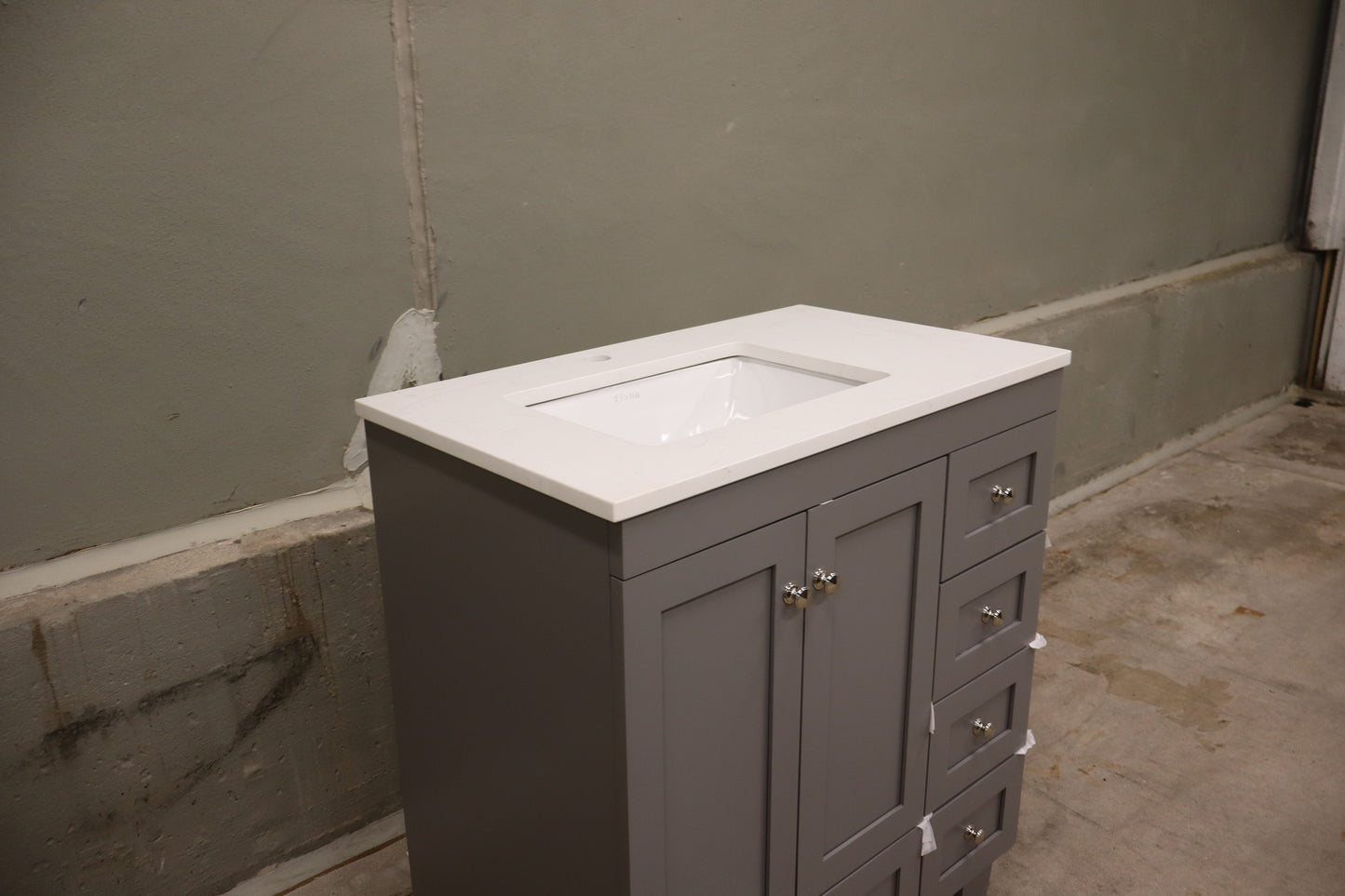 30-inch Gray Bathroom Vanity with a Carrara Quartz Countertop and Undermount Porcelain Sink.