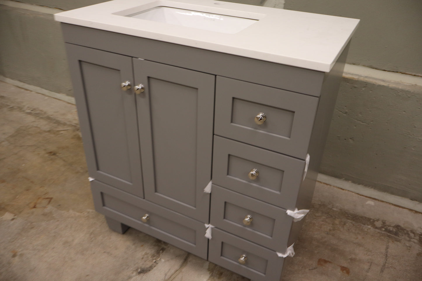 30-inch Gray Bathroom Vanity with a Carrara Quartz Countertop and Undermount Porcelain Sink.