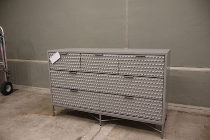Milo 7 Drawer Dresser, featuring a taupe finish with textured drawer faces and pewter hardware. 