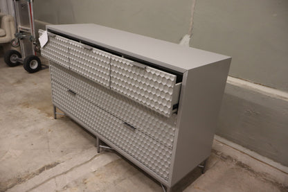 Milo 7 Drawer Dresser, featuring a taupe finish with textured drawer faces and pewter hardware. 